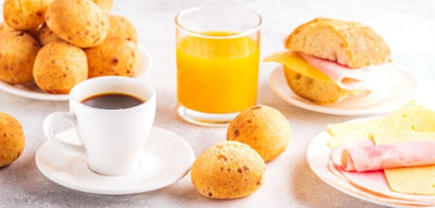 Traditional Brazilian breakfast - pao de quijo, cheese bread, 3 Coracoes Extraforte Ground Coffee, ripe fruit. 