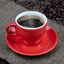 Red cup of Cafe Brasileiro Extraforte coffee on coffee beans background. 