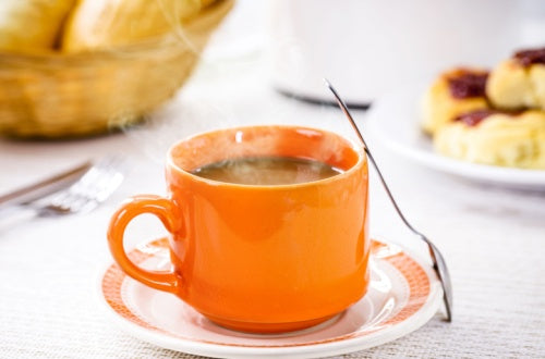 Melitta Tradicional coffee with milk, traditional Brazilian breakfast drink, served hot with bread and toast