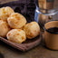 Table with delicious Pão de Queijo, a mug of Cafe Do Ponto Exportacao coffee and a traditional coffee maker