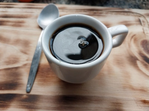 Cup of Brazilian café do ponto extraforte coffee with spoon