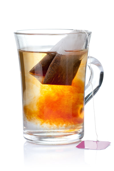Glass mug of antigripal tea with tea bag