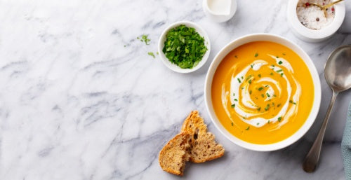 Monte Cudine pumpkin soup in bowl with bread and spices