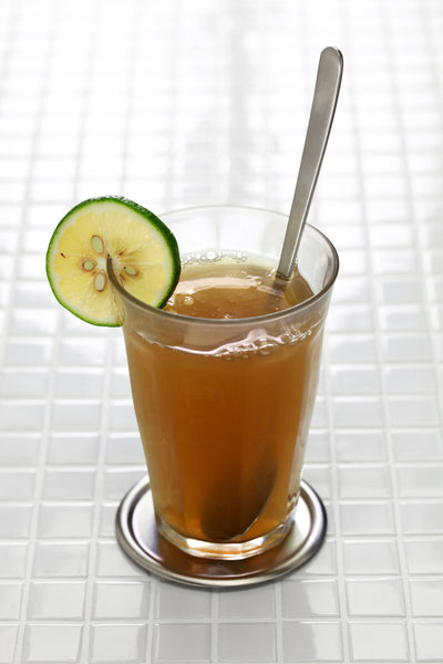 Glass of emolient with spoon and lime