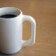 Hot Black 3 Coracoes Café Descafeinado Coffee in a White Ceramic Mug. Decaffenated coffee