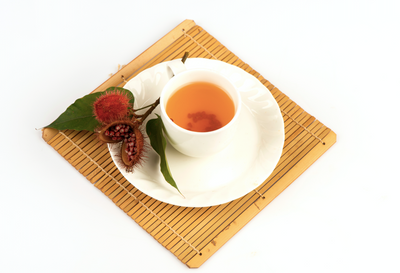 Annatto tree, dried fruits, seeds, brewed into a healthy tea in white cup