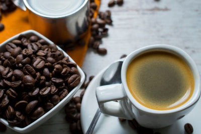 Café Bustelo Espresso Coffee in white cup, Coffee beans on the table.