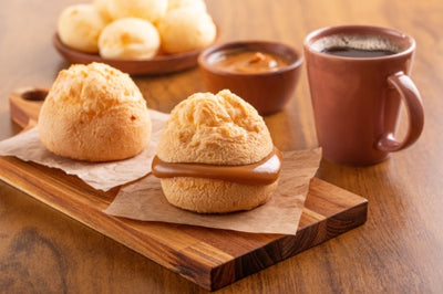 Brazilian snack. Pão de Queijo filled with dulce de leche. Cafe Melitta Tradicional Black coffee. Breakfast.