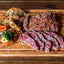 Celusal BBQ Iodized salt sprinkled on Argentine cut of meat called Vacio  and vegetables.