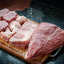 Dos Anclas Sal Parrillera Seasoning barbecue meats with coarse salt. Putting coarse salt by hand on the barbecue cuts of picanha, ribs, chicken, ancho.