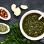 Aji molido ground chili pepper, garlic, seasonings bowl of chimichurri sauce