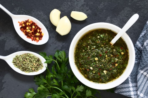 Aji molido ground chili pepper, garlic, seasonings bowl of chimichurri sauce