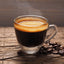 Cup of hot Pilon Gourmet Cafe Molido Cafe Espresso, coffee beans on table