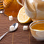 tea, pot and honey on table