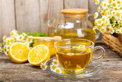 Cup of tea with lemon honey and flowers