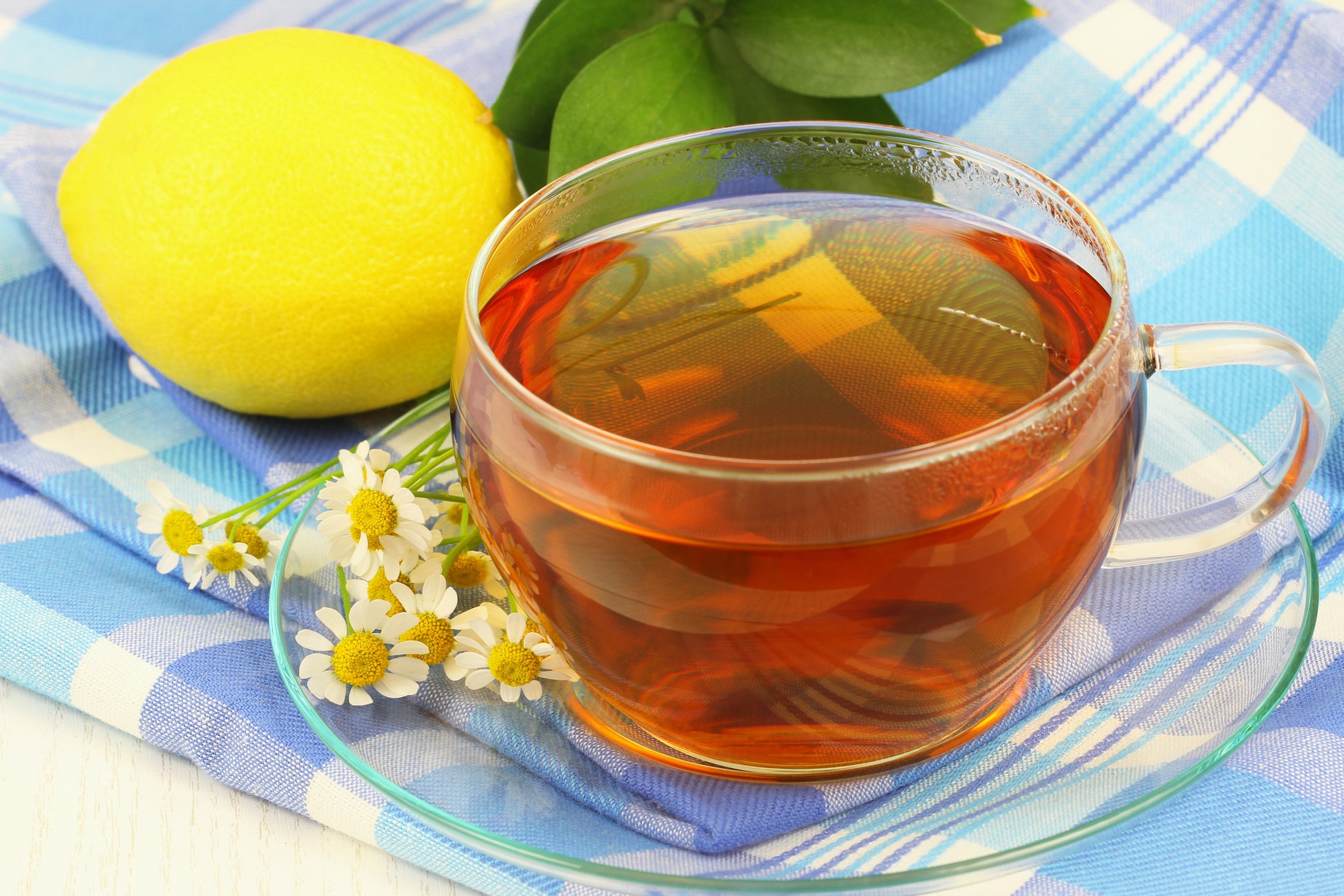 Glass cup of digestivo tea with chamomile, mint and lemon